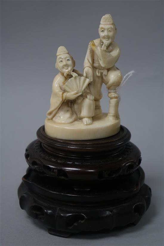 A Japanese ivory okimono and two stands, 3.25in.